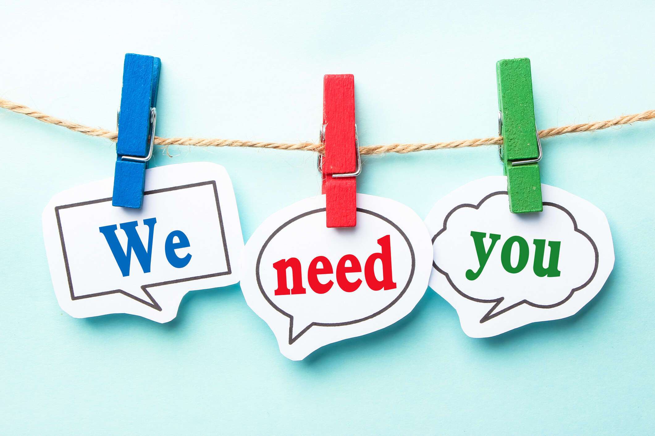 We Need You signs held on string line with clothes pegs